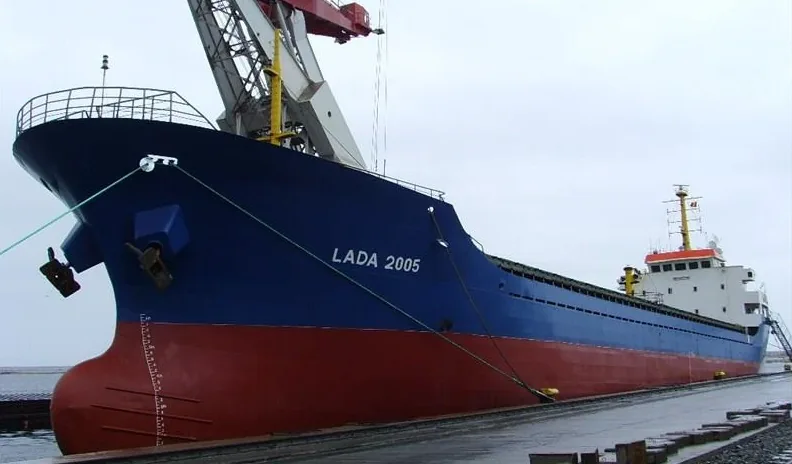 Lada 2005 moored alongside, with a shore crane above her bow